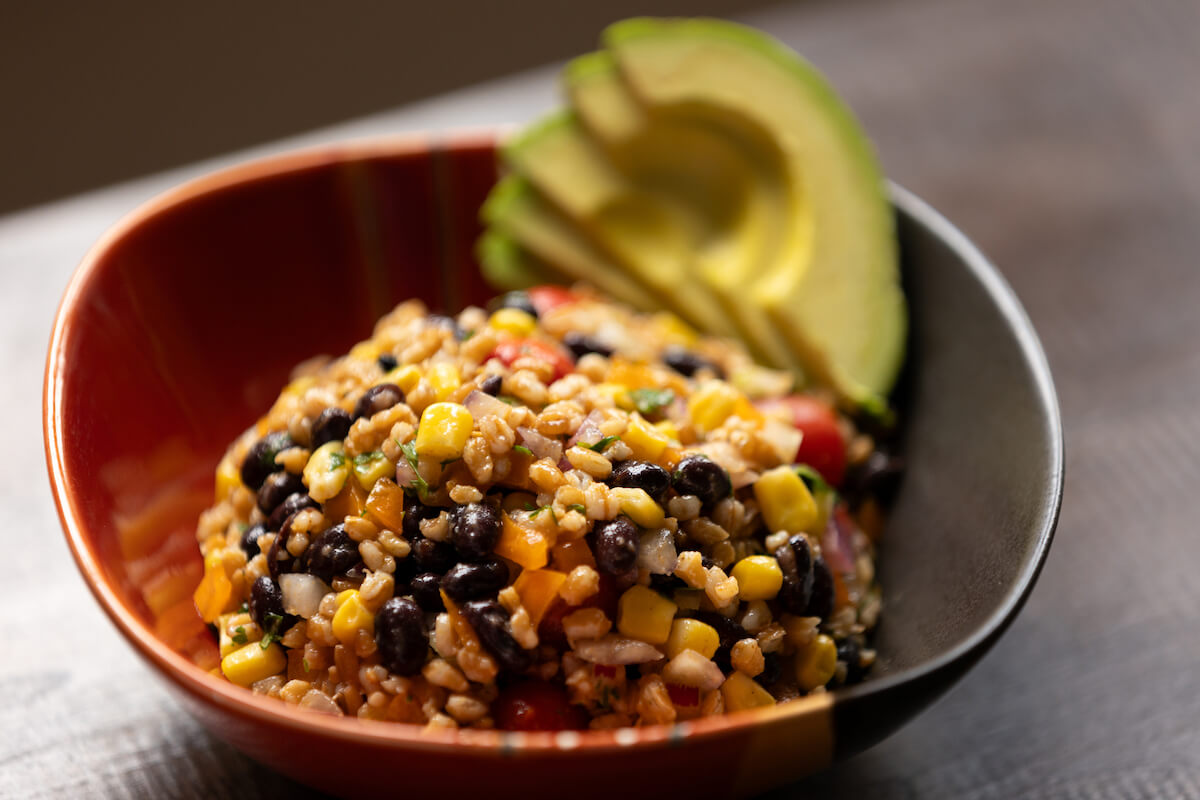 bowl of farro and beans and avocado